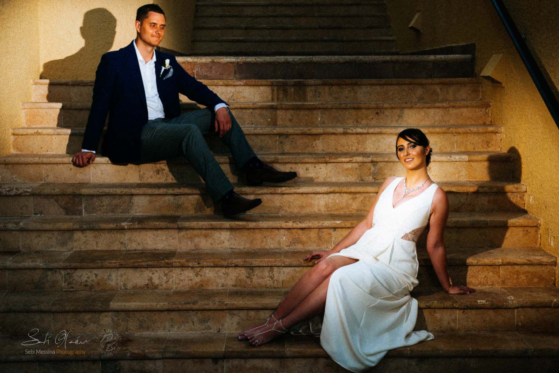Bride and groom sitting on the stairway 