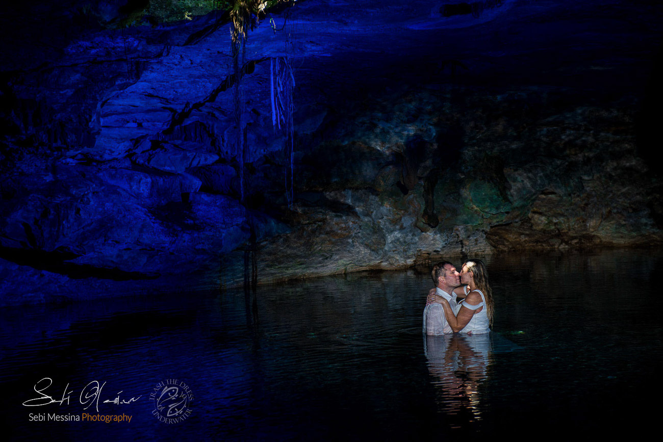 Brides and groom inside the cave of a cenote near Cancun